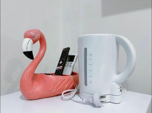 a red swan and a white mug on a counter at 104 Chic Queen BR with Fast WiFi - Brunswick East in Melbourne