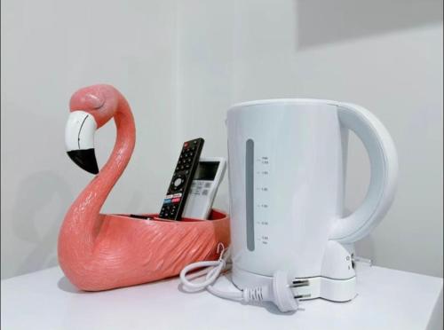 a red swan and a white mug on a counter at 205 Modern King BR with Fast WiFi - Brunswick East in Melbourne