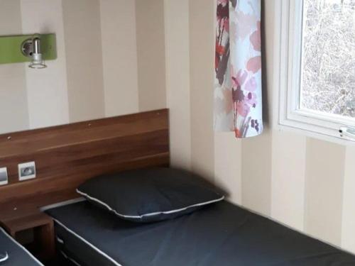 a mattress sitting on a table next to a window at Mobil-Home Confortable 3 Chambres avec Terrasse - API-1-52-399 in Saint-Sornin