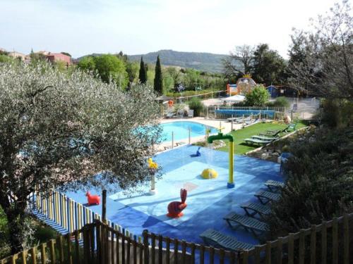 a large swimming pool with a playground in a park at Mobil-home cosy 2 chambres en Provence - API-1-52-437 in Venterol