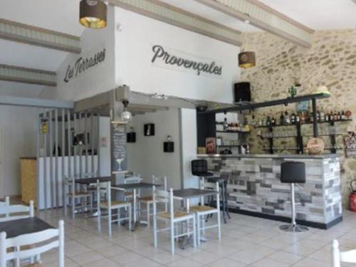 a restaurant with tables and chairs and a bar at Mobil-home cosy 2 chambres en Provence - API-1-52-437 in Venterol