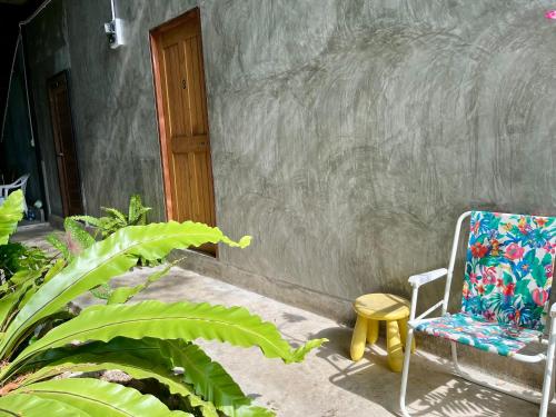 a chair sitting on the porch of a house at Nokhook House in Trang