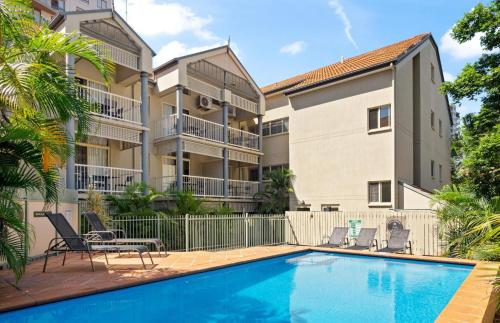a swimming pool in front of a apartment building at Bridgewater Rivercity in Brisbane