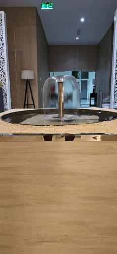 a table in a room with a fountain in it at Sugardunes Beach Resort in Ghadw