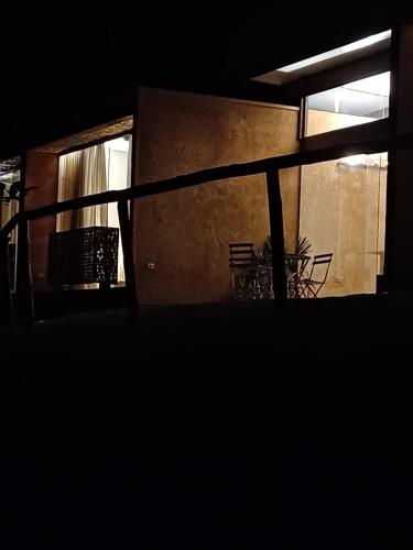 a dark room with chairs and a window at Fraga da Mantiqueira in São Bento do Sapucaí