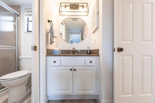 a bathroom with a sink and a mirror at Park Shore Resort-Deluxe Condo 1st FloorBLDGE 134 in Naples