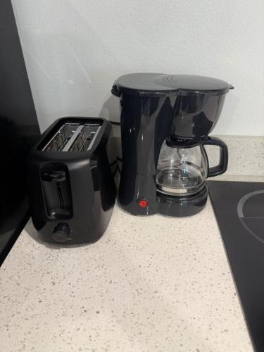 a coffee maker and a toaster sitting on a counter at Stylish Studio on Lake Conroe in Montgomery