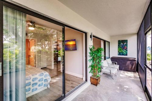 a room with sliding glass doors leading to a bedroom at Park Shore Resort-1st Floor Condo-Park 101 in Naples