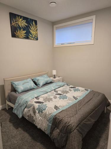 a bedroom with a bed and a window in it at Guest Suite in Southwest Calgary in Calgary