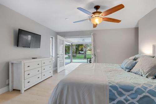 a bedroom with a bed and a ceiling fan at 4BR 6BD Pool HotTub Atlantic Ave in Delray Beach