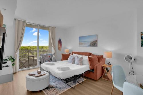 a living room with a bed and a couch at 1 br 2bed LakeView Rooftop Pool in Boynton Beach