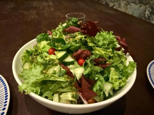 a salad in a white bowl on a table at Kiao Beach in Anepahan