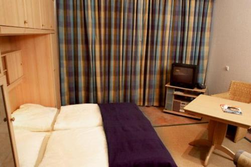 a hotel room with a bed and a television at Kaiserhof 010 in Wangerooge