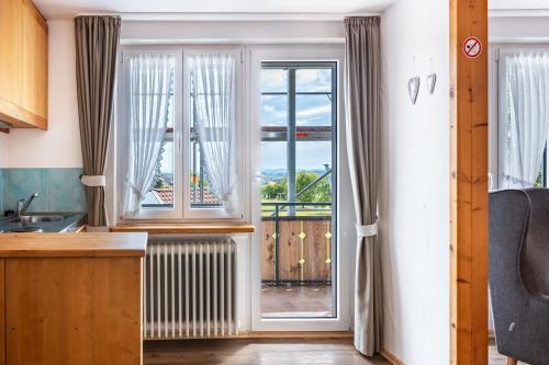 a kitchen with a window and a view of the ocean at Pension Ferienwohnung Baarblick in Donaueschingen