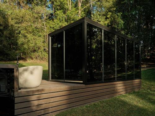 a gazebo with a tub sitting on a deck at Luxury Mirror Home In Byron Bay in Byron Bay
