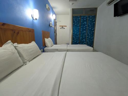 a large white bed in a room with a window at Midah Inn Hotel Puchong in Batu Caves
