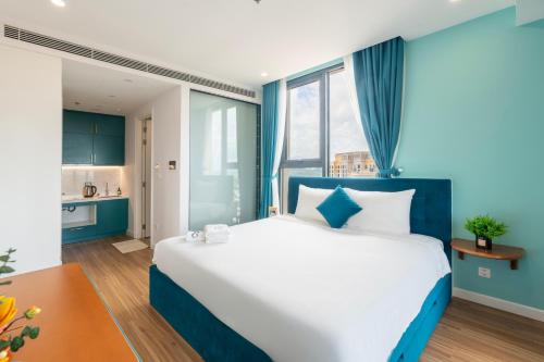 a blue and white bedroom with a large bed at Luna Sol Villas - Dedicated Care Until Check Out in Phu Quoc