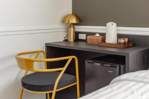 a bedroom with a desk with a chair and a bed at Sunset Mu Style Inn in Xiaoliuqiu