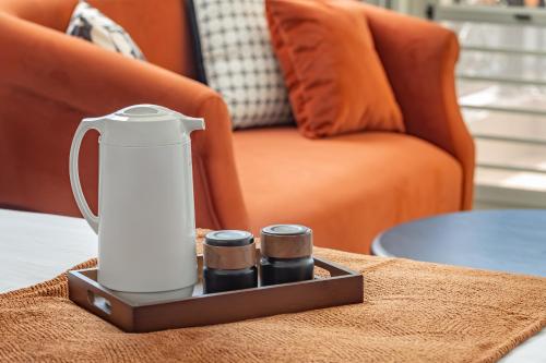 a tea kettle on a table next to a couch at Sunset Mu Style Inn in Xiaoliuqiu