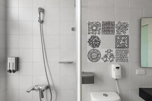 a bathroom with a shower and a toilet at Sunset Mu Style Inn in Xiaoliuqiu