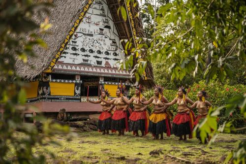 a group of women standing in front of a building at Four Seasons Explorer Palau - Cruising Resort in Koror