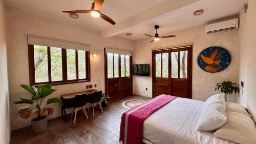 a bedroom with a bed and a table and chairs at Casa Serendi in Mazunte