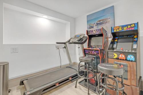 a room with a video game machine and a bar stool at Vessel Hotel Studio Suites of Atlanta, GA in Atlanta