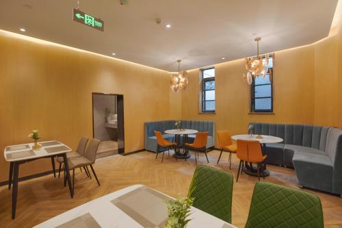 a restaurant with tables and chairs in a room at Orange Beijing Yansha Landmark Hotel in Beijing