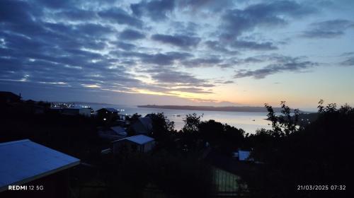 a view of the ocean at sunset at Tu Refugio Quellon in Quellón