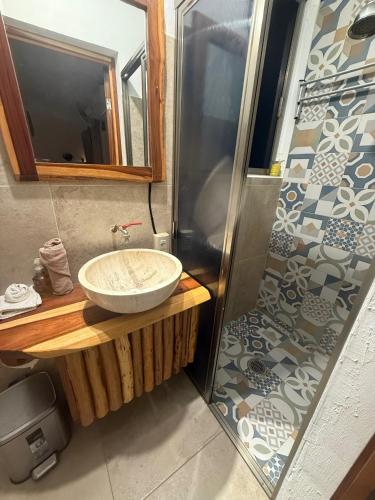 a bathroom with a sink and a shower at Casa Lamat in Bacalar