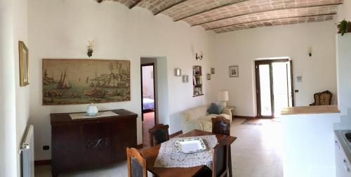 a living room with a table and a couch at Agriturismo Casal Taccone in Tarquinia