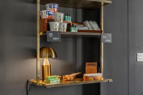a shelf with a lamp and other items on it at Sunset Mu Style Inn in Xiaoliuqiu