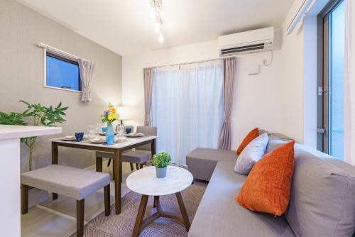 a living room with a couch and a table at 6 min to Nagoya Brand-new building Sleeps 5 in Nagoya