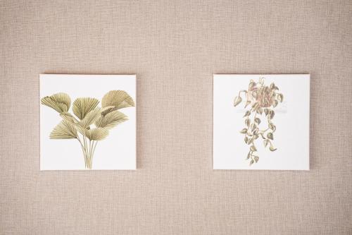 two framed drawings of flowers on a wall at 島原の宿翠泉 in Shimabara
