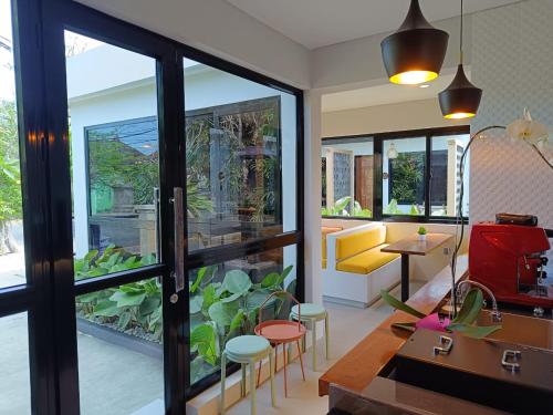 a living room with a large glass door at Padinis Villa & Coffee in Ketewel