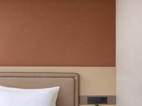 a headboard of a bed in a room at Immersing Hotel Guilin Two Rivers and Four Lakes Dongxi Alley in Guilin