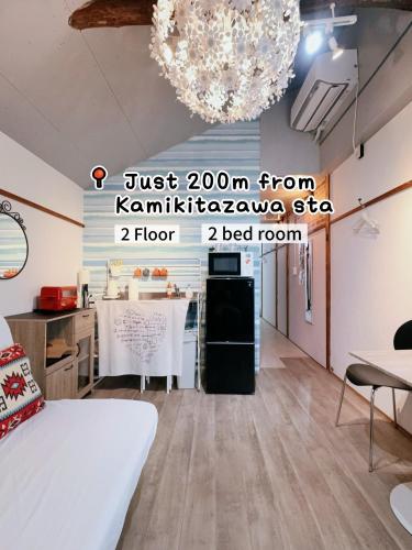 a room with a bed and a table and a chandelier at 2 type room, Akira&chacha guest home杉並区世田谷direct to shinjuku for 13 min 上北沢3分 近涉谷新宿Suitable for three or more people in Tokyo