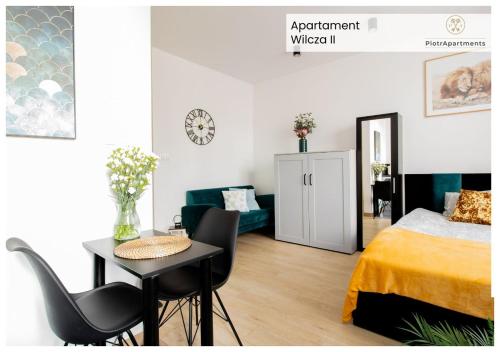 a bedroom with a bed and a table and chairs at PiotrApartments - Big City Life Apartments in Central Warszawa in Warsaw
