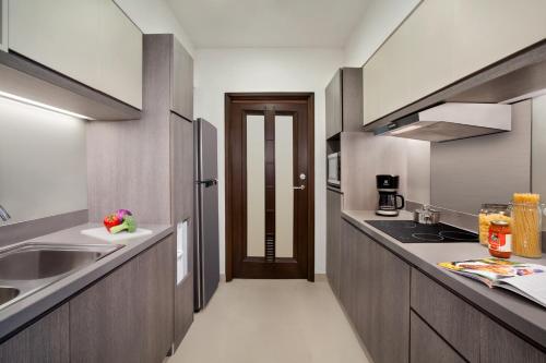 a kitchen with a sink and a counter top at Somerset Grand Citra Jakarta in Jakarta