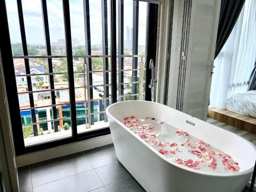 a bathroom with a bath tub with flowers on it at Midvalley Mosaic Southkey Muji w 3BR bathtub by Our Stay in Johor Bahru