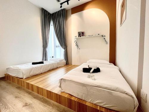 two beds in a room with a mirror at Midvalley Mosaic Southkey Muji w 3BR bathtub by Our Stay in Johor Bahru