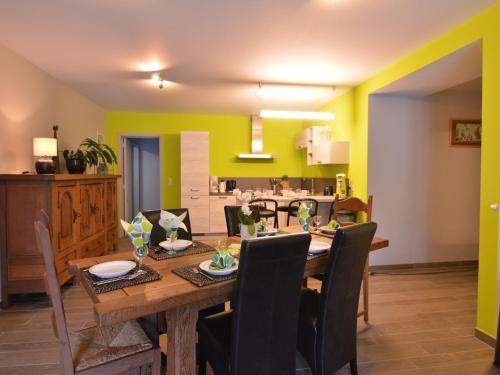 a dining room with a wooden table and chairs at Cozy Holiday home in Theux in Theux