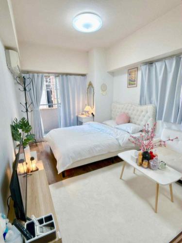 a bedroom with a bed and a living room at The Isabella Yokohama in Yokohama