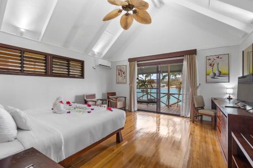 a bedroom with a bed and a ceiling fan at Iririki Island Resort & Spa in Port Vila