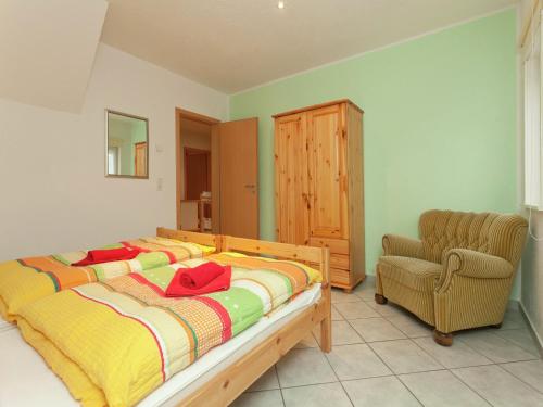a bedroom with a bed and a chair in it at Luxuriöser Wellnessaufenthalt in Elend in Elend
