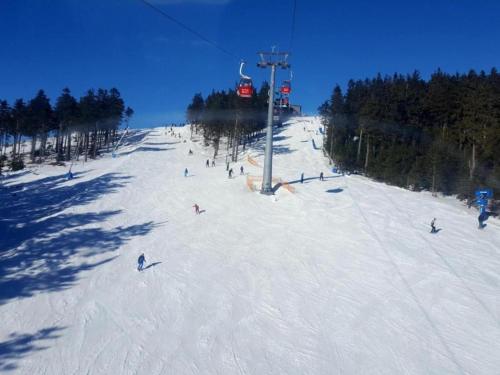a group of people skiing down a ski slope at Luxuriöser Wellnessaufenthalt in Elend in Elend