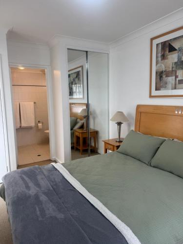 a bedroom with a bed and a bathroom at City CBD Retreat in Perth