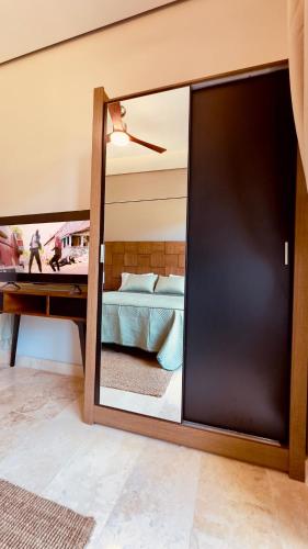 a sliding glass door in a bedroom with a bed at Jungle Guardian - Rooftop Pool & Beach Club in Zona Hotelera Tulum in Tulum