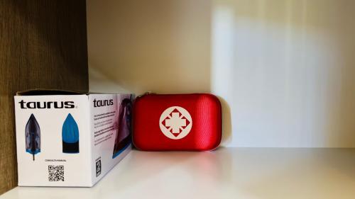 a red suitcase next to a box on a counter at Jungle Guardian - Rooftop Pool & Beach Club in Zona Hotelera Tulum in Tulum