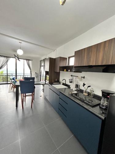 a kitchen with blue cabinets and a table in it at Ënxë Hotel Green in Cuetzalán del Progreso